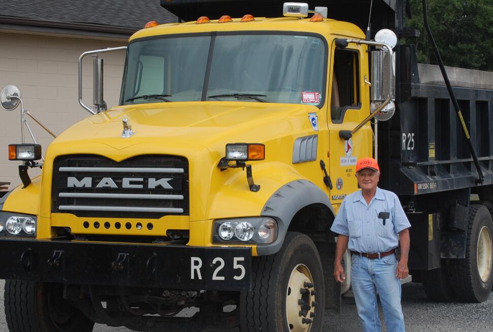 man standing in front of his truck
